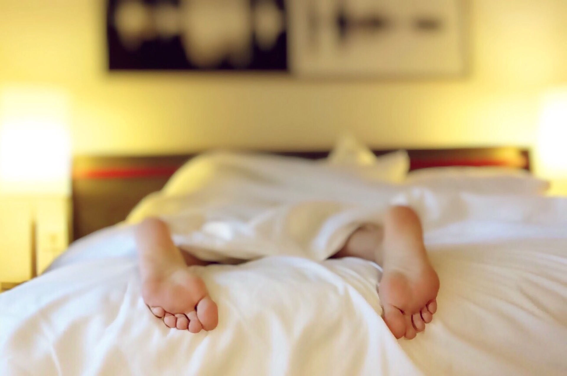 Sleep Deprivation With A Newborn + Newborn Sleep Tips woman in bed suffering from sleep deprivation with a newborn