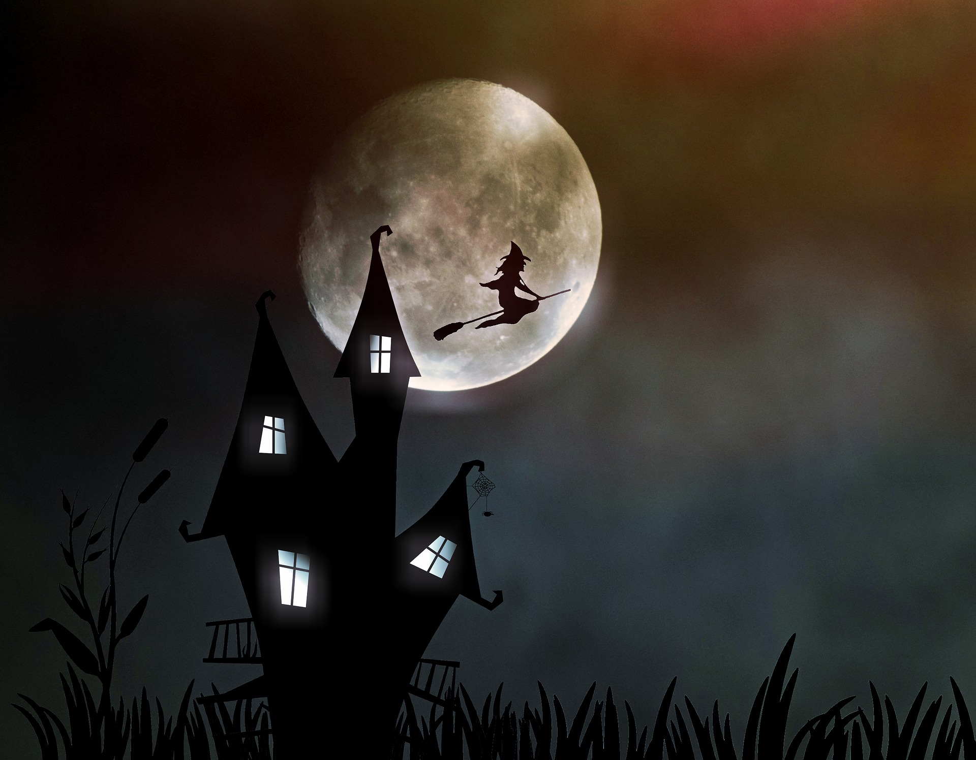 A spooky building and a full moon at halloween