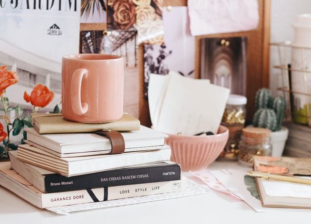 Books and a mug on a desk